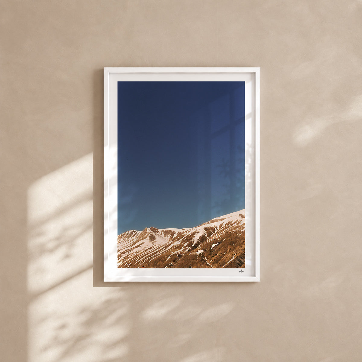 Snow-streaked ridges under a deep blue sky, French Alps, France — analog film photography print in a white wood frame