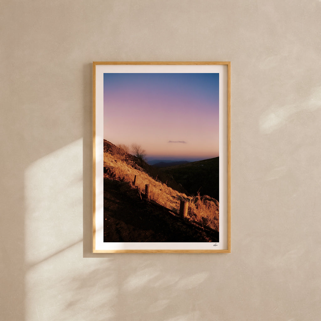 Winter dusk over the Chaîne des Puys, Auvergne, France — analog film photography print framed in natural oak