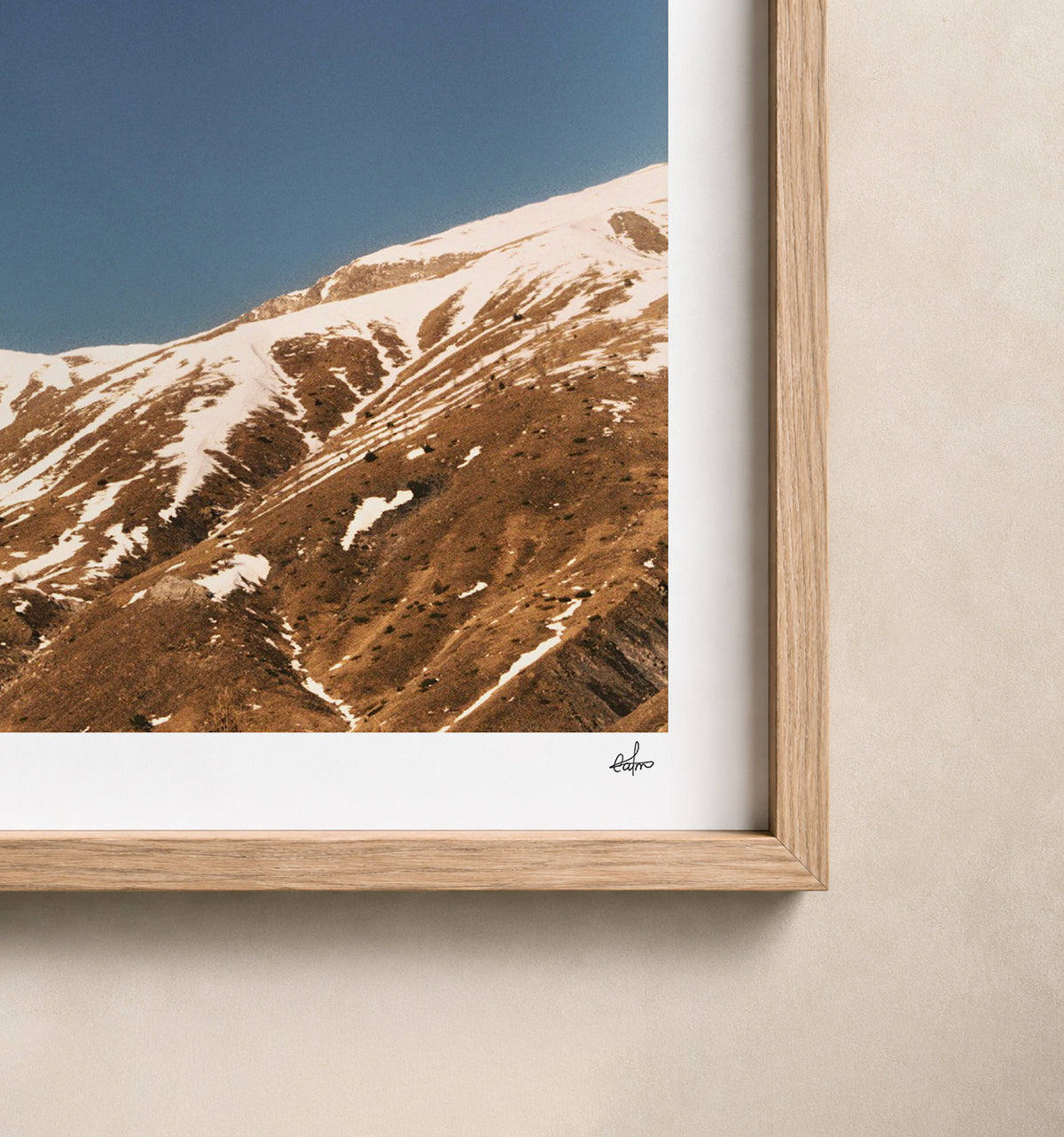 Snow-streaked ridges under a deep blue sky, French Alps, France — close-up of the print's white border and oak frame