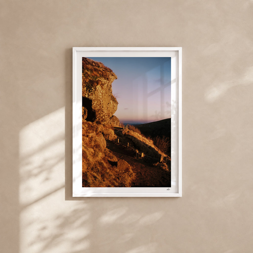 Golden winter light on a volcanic rock at the Puy de Clierzou, Auvergne, France — analog film photography print in a white wood frame