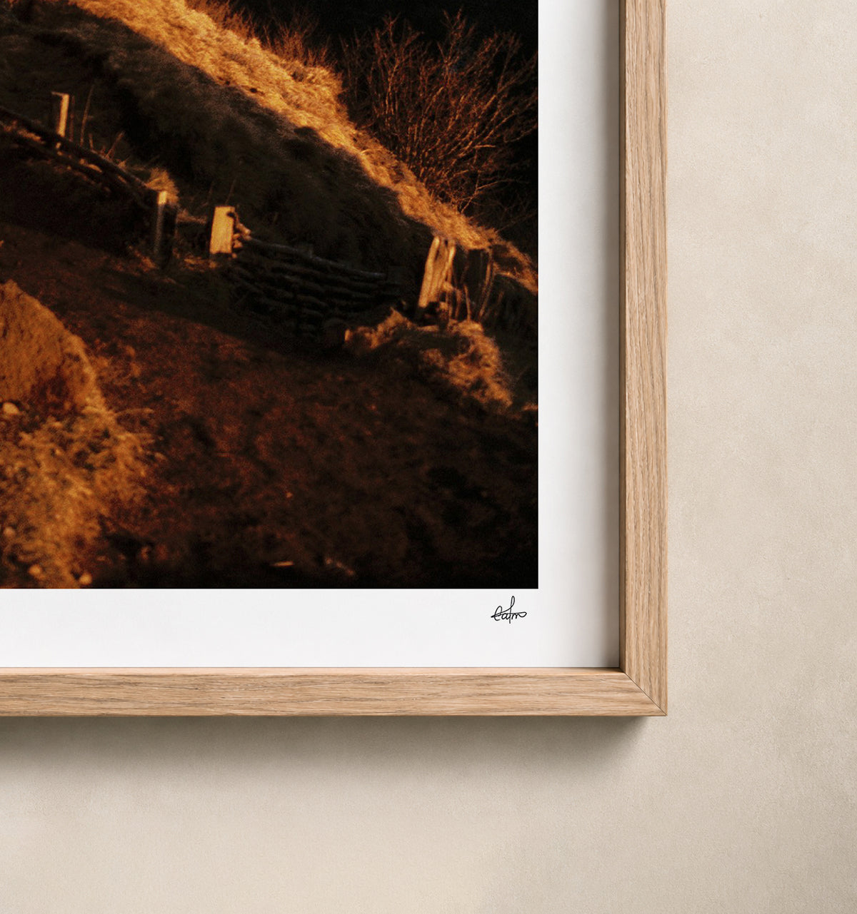 Golden winter light on a volcanic rock at the Puy de Clierzou, Auvergne, France — close-up of the print's white border and oak frame